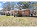 Quaint brick home with a front porch and lush green lawn at 5630 Jones Sausage Rd, Garner, NC 27529