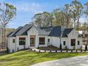 Beautiful single-story home boasts a dark roof, a white exterior, and a green, landscaped yard at 63 Pennington Cir, Chapel Hill, NC 27517