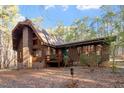 Charming two-story home boasts a wood exterior with a brick chimney and a cozy front porch at 735 Jordan Hills Loop, Chapel Hill, NC 27517