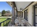 Spacious outdoor balcony with stone flooring, wrought iron railing, and stunning views at 7504 Everton Way, Wake Forest, NC 27587