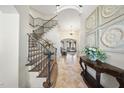 Elegant foyer with grand staircase, tile floors, and ornate wall decor leads into a dining and living area at 7504 Everton Way, Wake Forest, NC 27587