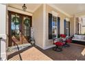 Cozy front porch with seating area, double front door with wreath and side lights at 804 Cambridge Hall Loop, Apex, NC 27539