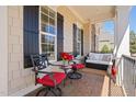 Relaxing front porch seating area with stylish chairs, table and love seat at 804 Cambridge Hall Loop, Apex, NC 27539