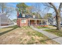 Beautiful brick house with a covered front porch and manicured lawn and inviting curb appeal at 818 Eastern Ave, Rocky Mount, NC 27801