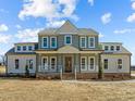 Two-story home with a welcoming front porch and manicured yard at 109 Little Lady Trail, Zebulon, NC 27597