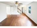 Spacious living room with hardwood floors, white trim, and staircase leading to the upper level at 1100 Walter Clark Dr, Hillsborough, NC 27278