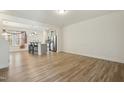 Spacious living room featuring modern flooring, an open floorplan, and a large window allowing lots of light at 116 Polaris Ave, Garner, NC 27529