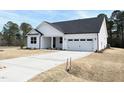 Beautiful one story white home with a two car garage and concrete driveway at 136 Tee Time Ter, Benson, NC 27504