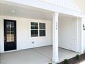 Inviting front porch with black front door and visible house number at 136 Tee Time Ter, Benson, NC 27504