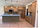 A modern kitchen with an island, stainless steel appliances, and pendant lighting at 141 Noramac Ct, Selma, NC 27576