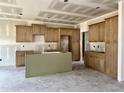 The kitchen features newly installed cabinets, with a large island for ample space in this unfinished space at 141 Noramac Ct, Selma, NC 27576