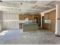 A kitchen with ample cabinets and a central island under construction at 141 Noramac Ct, Selma, NC 27576
