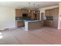 A modern kitchen with an island, stainless steel appliances, and pendant lighting at 141 Noramac Ct, Selma, NC 27576