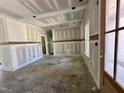 A spacious living room featuring paneled wainscoting and a modern, open design at 141 Noramac Ct, Selma, NC 27576