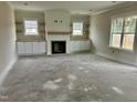 Bright living room featuring a fireplace, built-in shelving and plenty of natural light at 141 Noramac Ct, Selma, NC 27576