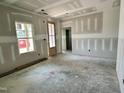 Unfinished living room features a window offering views and a doorway leading to other rooms in the house at 141 Noramac Ct, Selma, NC 27576