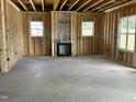 Unfinished living room with wood framing and newly installed fireplace at 141 Noramac Ct, Selma, NC 27576