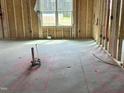 Unfinished living room shows framing, electrical work and the location of the rooms future appliances at 141 Noramac Ct, Selma, NC 27576