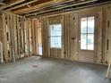 Unfinished room features natural light from a large window and a doorway to another section of the house at 141 Noramac Ct, Selma, NC 27576