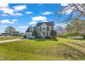 Inviting two-story home features a well-kept lawn, a two-car garage, and mature landscaping at 154 Ashton Ln, Angier, NC 27501