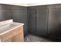 Stylish bathroom showcasing modern fixtures and elegant black wainscoting at 163 Noramac Ct, Selma, NC 27576