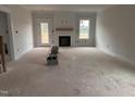 Spacious living room with a fireplace and a doorway leading to the exterior at 163 Noramac Ct, Selma, NC 27576