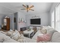 Cozy living room with comfortable sofa, ceiling fan, TV, and stylish decor, creating a welcoming atmosphere at 170 Buckaroo Dr, Louisburg, NC 27549