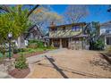 Two-story home boasts a beautifully landscaped front yard and gravel driveway at 1714 Park Dr, Raleigh, NC 27605