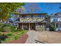 Charming two-story home with a landscaped front yard and a brick walkway at 1714 Park Dr, Raleigh, NC 27605