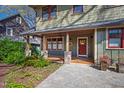 Inviting front porch featuring stone supports, a wooden ceiling, and a red front door at 1714 Park Dr, Raleigh, NC 27605
