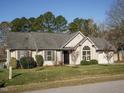 Inviting one-story home featuring a well-maintained lawn, updated siding, and an attached garage at 216 Orkney Rd, Stem, NC 27581