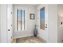 Bright foyer with a patterned glass door, stylish vase, and elegant rug at 236 Annabelle Blue Dr, Wake Forest, NC 27587