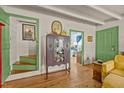Inviting home entryway featuring hardwood floors and green-trimmed doorways at 2409 Hodges Rd, Burlington, NC 27217