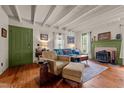 Comfortable living room features a fireplace, wood floors, beamed ceilings, and stylish decor at 2409 Hodges Rd, Burlington, NC 27217