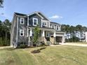 Attractive craftsman home with covered porch, two-car garage, and meticulously landscaped front yard at 266 Golfview Ave, Benson, NC 27504