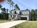 Well-manicured two-story home boasts stone accents, a covered porch, and a spacious two-car garage at 266 Golfview Ave, Benson, NC 27504