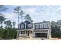 Two-story home with gray siding and a covered porch, awaiting its final touches at 266 Golfview Ave, Benson, NC 27504