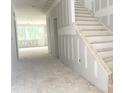 Unfinished interior showcasing a staircase and an open-concept layout with natural light at 266 Golfview Ave, Benson, NC 27504