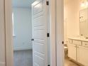 A doorway highlights a vanity with white cabinetry leading to a bedroom at 283 Golfview Avenue, Benson, NC 27504