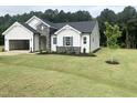 Exterior showcasing a new construction home with manicured lawn and tree at 283 Golfview Avenue, Benson, NC 27504