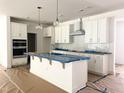 Spacious kitchen with stainless steel appliances, a center island and white cabinets at 283 Golfview Avenue, Benson, NC 27504