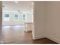 Bright, open-concept living space with luxury vinyl flooring, large windows, and modern finishes at 283 Golfview Avenue, Benson, NC 27504