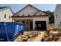 New construction home showing the unfinished exterior and two car garage on a sunny day at 346 Bluejay St, Clayton, NC 27520