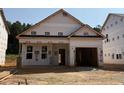 New construction home featuring a covered entryway and a convenient attached two-car garage at 346 Bluejay St, Clayton, NC 27520