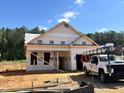 New construction home featuring a covered porch and bright facade, ready for your personal touch at 346 Bluejay St, Clayton, NC 27520