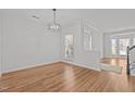 Spacious living room with hardwood floors, fresh paint, and plenty of natural light at 3509 Archdale Dr, Raleigh, NC 27614