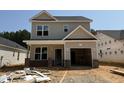 New construction, featuring a two-story home with an attached one-car garage and brick-accented entryway at 354 Bluejay St, Clayton, NC 27520