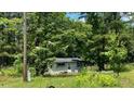 Charming home nestled among lush trees, offering a private and tranquil setting at 3541 Holden Acres Dr, Wendell, NC 27591
