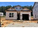Exterior view of a new construction home with covered entry and attached garage at 362 Bluejay St, Clayton, NC 27520