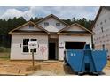 New construction featuring a modern design, visible window frames, and durable exterior wrap on a sunny day at 362 Bluejay St, Clayton, NC 27520